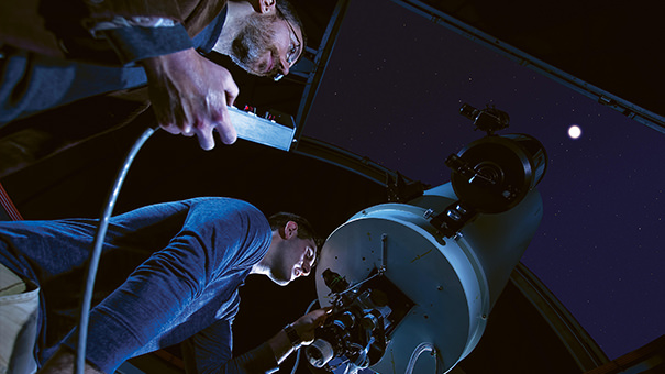 A student and professor using the college observatory. 