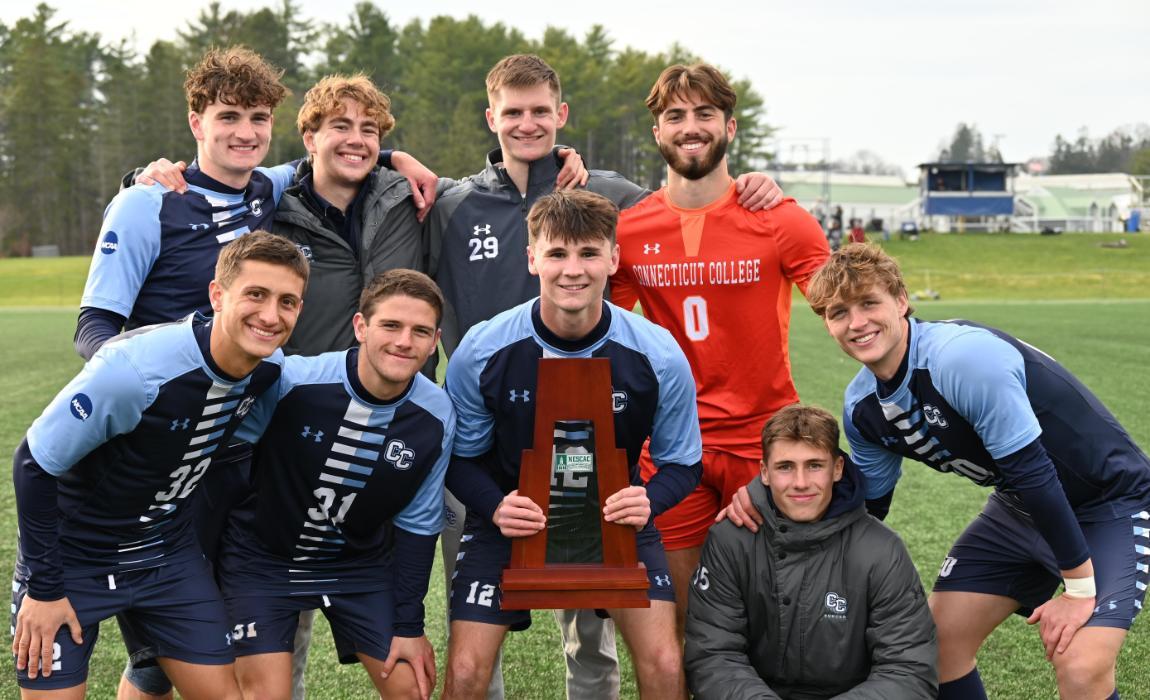 Juniors of the Men's Soccer Team Pose with Trophy.