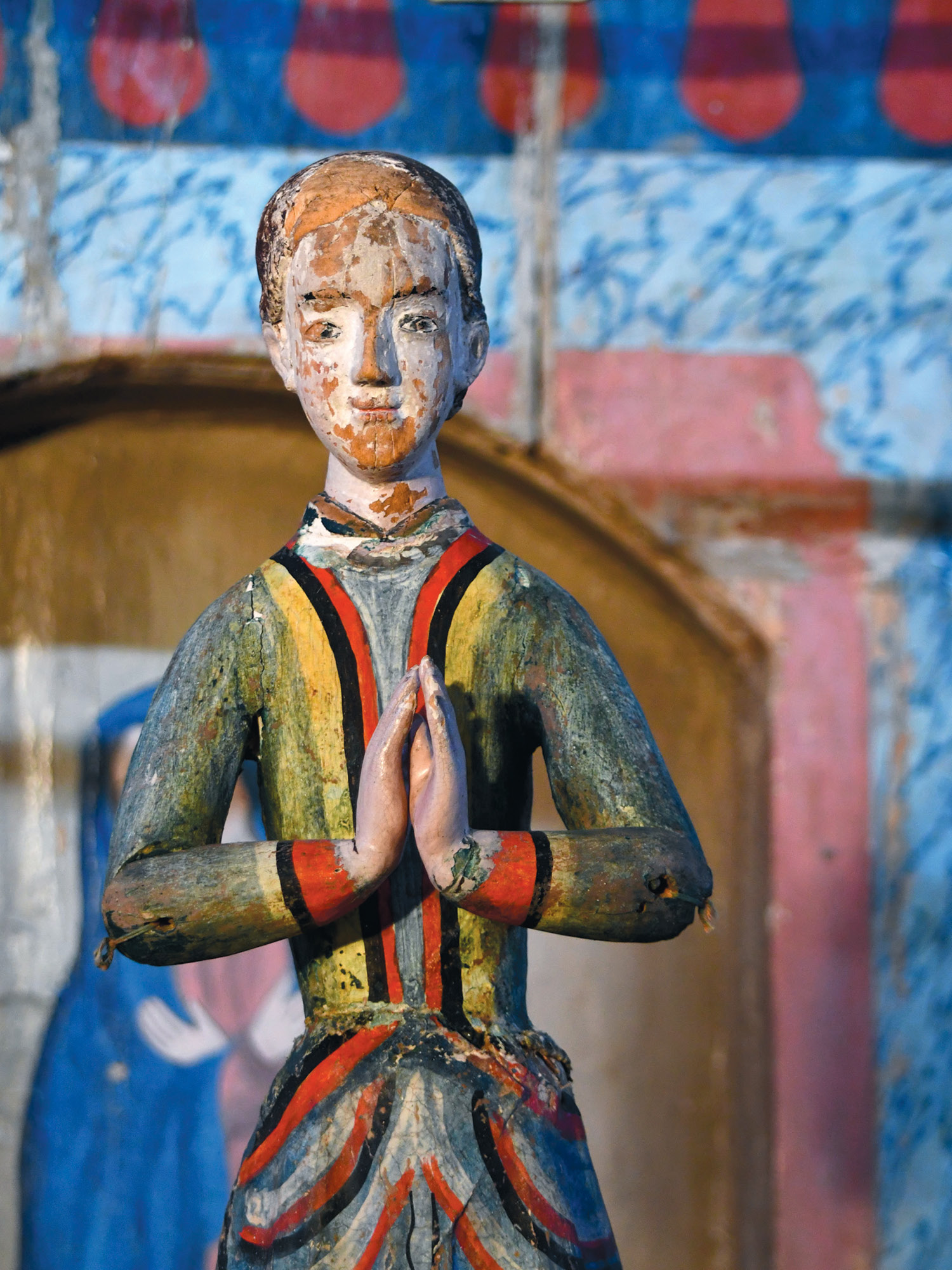 Image of worship statue in an old adobe mission church