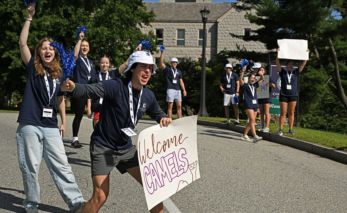 Student leaders cheer as new students arrive on campus.