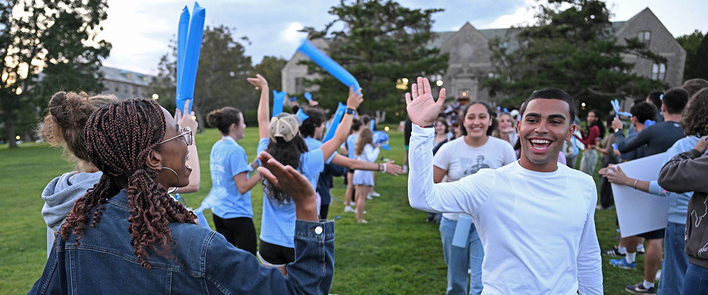 Student leaders high five new students as they take their "New Camel Walk" on Tempel Green.