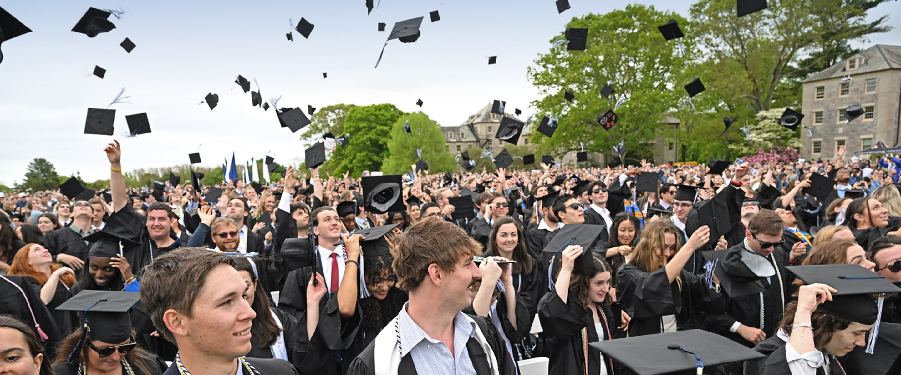 Members of the Class of 2024 toss their caps at Commencement.