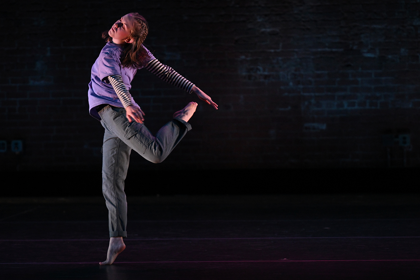 a solo dancer strikes a pose on stage