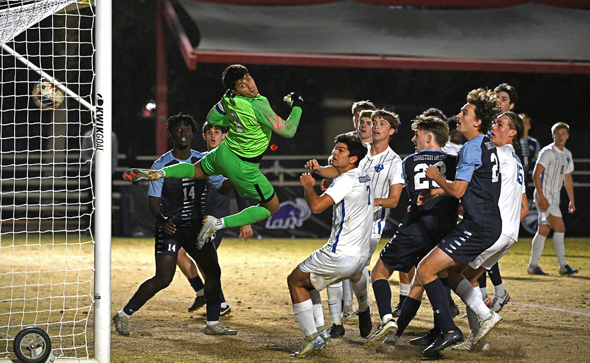 Players from both teams watch as Conn's free kick sails into the net.